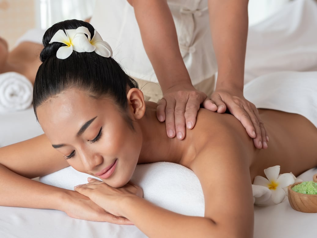 Asian woman are relaxing shoulder massage in the Spa Salon. Thai massage for health. Select focus hand of masseuse